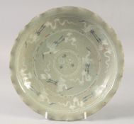 A 19TH CENTURY KOREAN DISH, decorated with cranes, 26cm diameter.