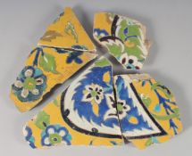 A COLLECTION OF FIVE 17TH CENTURY PERSIAN SAFAVID GLAZED POTTERY TILE FRAGMENTS, with yellow