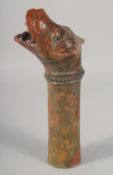 AN 18TH-19TH CENTURY INDIAN GLAZED POTTERY WATER SPOUT in the form of a Makkara dragon, 28cm long.