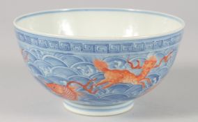 A CHINESE BLUE, WHITE AND CORAL RED PORCELAIN BOWL, painted with carp and various beasts amongst