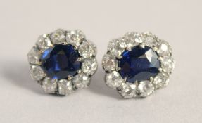 A SUPERB PAIR OF EDWARDIAN NATURAL SAPPHIRE AND DIAMOND SET OVAL CLUSTER EARRINGS.