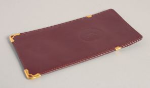 A CARTIER LEATHER CIGARETTE CASE in a red Cartier velvet case.