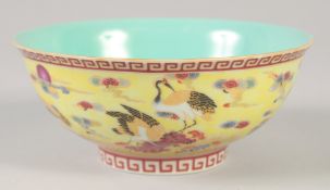 A CHINESE YELLOW GROUND FAMILLE ROSE BOWL decorated with cranes, six character mark to base. 15cm