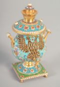 A SMALL RUSSIAN SILVER GILT AND ENAMEL SAMOVAR Mark: 84, 4ins high, 156gms.