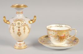 A 19TH CENTURY COALPORT GOLD GROUND CUP AND SAUCER painted with flowers and birds and a 19th century