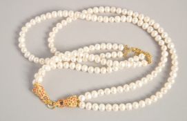 A PEARL NECKLACE with GOLD PLATED PANTHER CLASP.