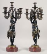 A VERY GOOD PAIR OF BRONZE AND GILDED BRONZE NUBIAN FIGURE FIVE-LIGHT CANDELABRA, each with four