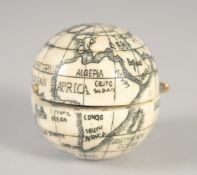 AN ETCHED BONE FOLDING GLOBE COMPASS. 1.5ins diameter.