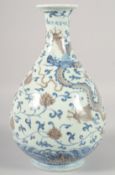 A CHINESE BLUE AND UNDERGLAZE RED PORCELAIN YUHUCHUNPIN VASE, painted with dragon and phoenix