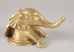A GILT BRONZE ELEPHANT on a circular base. 6ins