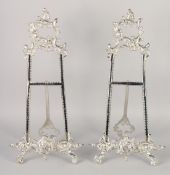 A PAIR OF SILVER PLATED EASELS. 18ins high.
