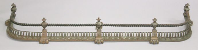 A 19TH CENTURY BRASS PIERCED FENDER with rope work. 4ft 3ins long 1ft 2ins deep.
