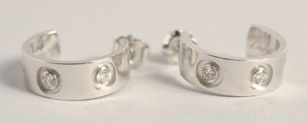 A PAIR OF CARTIER 18CT WHITE GOLD AND DIAMOND HOOP EARRINGS