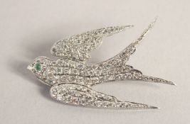 AN 18CT WHITE GOLD DIAMOND SET SWALLOW BROOCH.