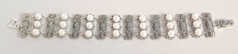 A SILVER PEARL AND MARCASITE WIDE BRACELET.