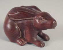 A JAPANESE CARVED WOOD RABBIT NETSUKE. Signed, 2ins.