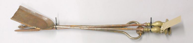 A PAIR OF BRASS AND STEEL FIRE IRONS.