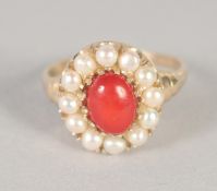 A 9CT GOLD CORAL AND PEARL RING.
