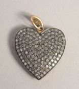 A VICTORIAN STYLE GOLD HEART SHAPED LOCKET set with rose diamonds.