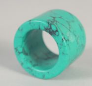 A TURQUOISE ARCHER'S RING.