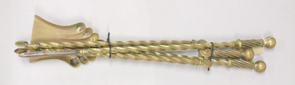 A SET OF THREE VICTORIAN BRASS FIRE IRONS.