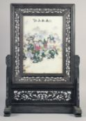 A CHINESE PORCELAIN SCREEN on a wooden stand.