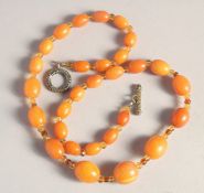 A BUTTERSCOTCH AMBER BEAD NECKLACE, twenty nine beads. Weight: 31gms, 20ins long.