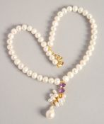 A PEARL NECKLACE with GOLD PLATED AMETHYST CLASP.