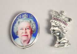 TWO SILVER QUEEN ELIZABETH II BROOCHES.