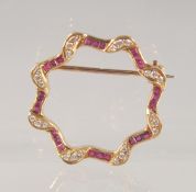 AN 18CT GOLD, DIAMOND, AND RUBY BROOCH. 2.5cm diameter.