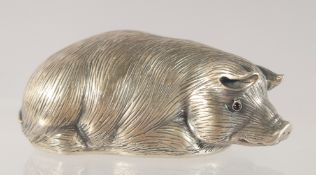 A RUSSIAN CAST SILVER MODEL OF A RECUMBENT PIG. Marks: Eagle, Head 88 I. P. Faberge. 32gms.