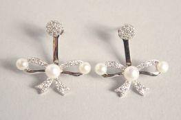 A PAIR OF SILVER BOW PEARL SET EARRINGS.