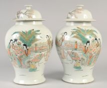 A PAIR OF CHINESE PORCELAIN TEMPLE JAR AND COVER painted with figures. 16ins high.