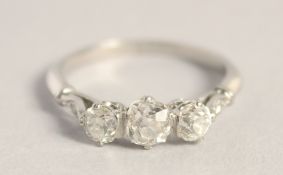 A PLATINUM THREE STONE DIAMOND RING.