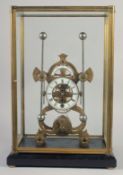 A BRASS SKELETON CLOCK with two enamel dials in a glass case. 19ins high.