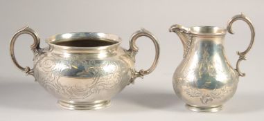 A VICTORIAN ENGRAVED SILVER TWO HANDLED CIRCULAR SUGAR BOWL AND MILK JUG. London 1848. Maker:
