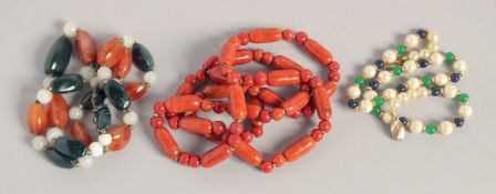 A TWO-COLOUR AGATE NECKLACE, THREE-COLOUR PEARL NECKLACE and an ORANGE STONE NECKLACE (3).