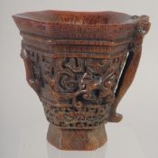 A GOOD CHINESE CARVED WOOD LIBATION CUP with handle. 5ins high.