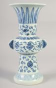 A CHINESE BLUE AND WHITE PORCELAIN GU VASE with floral decoration, six character mark to base. 33.