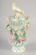 AN 18TH OR 19TH CENTURY VASE AND COVER with bird finial encrusted with flowers and face-mask