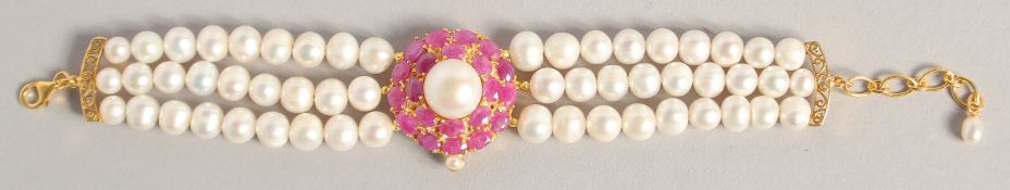 A PEARL BRACELET with GOLD PLATED RUBY CLASP.