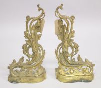 A GOOD PAIR OF 19TH CENTURY CAST BRASS CHENETS with acanthus decoration. 1ft 1ins high, 9ins wide.