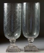 TWO CUT GLASS STORM LAMPS on square stepped bases. 15ins high.