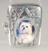 AN EDWARD VII SILVER VESTA CASE with an oval enamel of a Scottie dog. 1.5ins x.75ins Birmingham