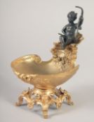 A GILT BRONZE AND BRONZE SALT with a cherub. 6.5ins.