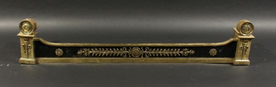A 19TH CENTURY BRASS FENDER of Adam design with quivers and roundels 3ft 10ins long, 9ins deep.