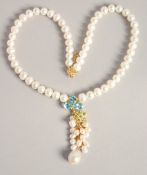 A PEARL NECKLACE with blue topaz and emerald necklace.