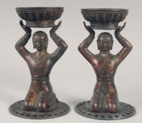 A PAIR OF TIBETAN GILT BRONZE CANDLESTICKS. 23cm high.