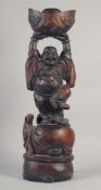 A CARVED ROSEWOOD BUDDHA. 26ins long.
