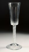 AN 18TH CENTURY TALL PLAIN ALE GLASS with air twist stem. 7.75ins high.